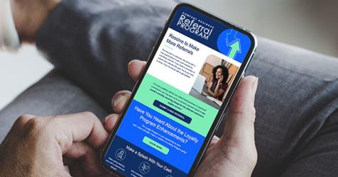 person reading referral incentive email on mobile device